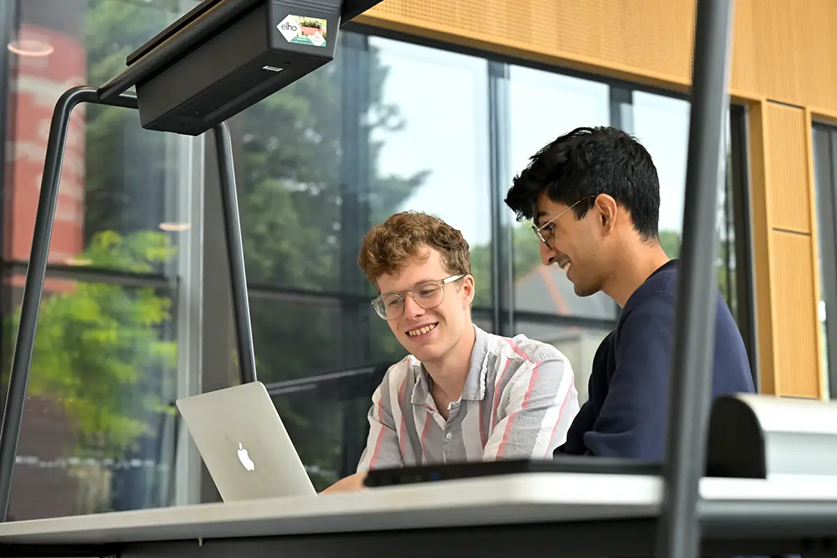 Two students at laptop