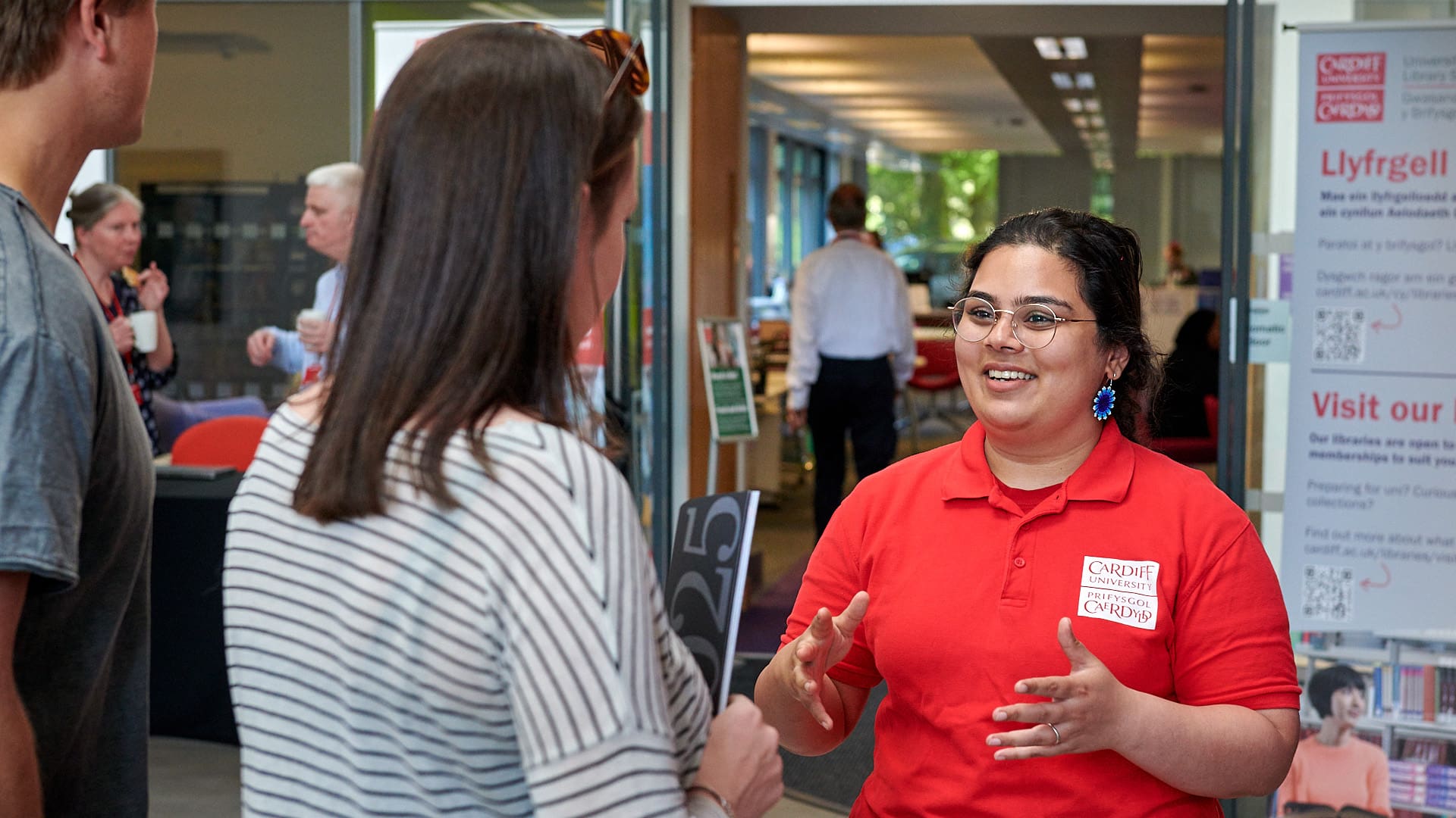 Cardiff University staff talking to prospective postgraduate student